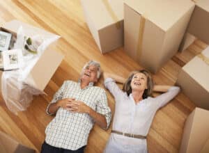 Happy couple laying on floor of new house