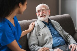 gentleman sitting on couch talking with health care provider