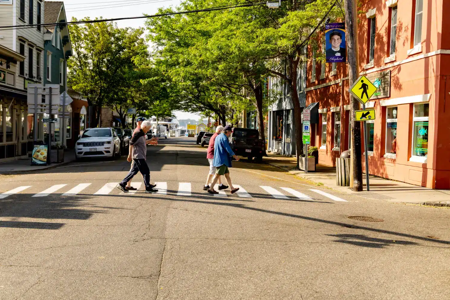downtown with residents walking across the street